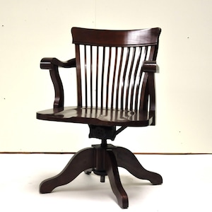 Antique adjustable desk chair in dark wood