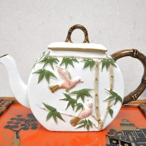 Vintage teapot with bamboo and birds