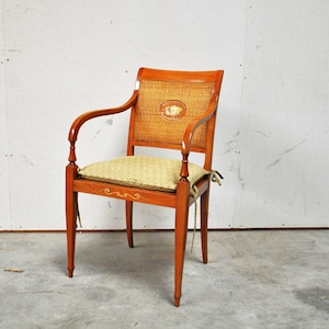 Antique wooden accent chair in wicker with floral back