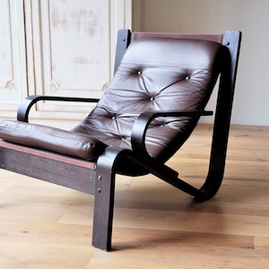 Midcentury lounge chair with a brown wooden frame