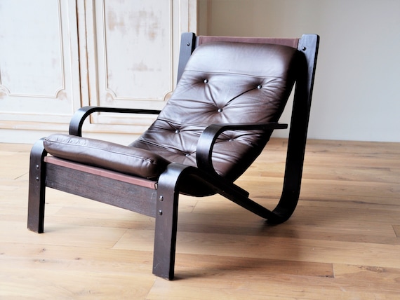 Midcentury lounge chair with a brown wooden frame