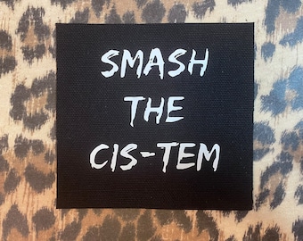May include: Black canvas patch with white text that reads "Smash the Cis-tem".