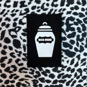 May include: Black patch with a white silhouette of a jar with the text "DEAD INSIDE" on a label.