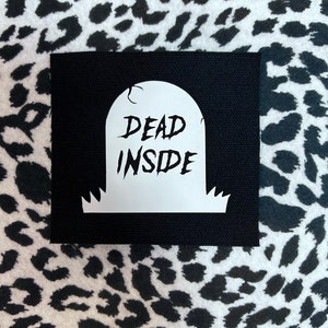 May include: Black fabric patch with a white tombstone graphic that says "DEAD INSIDE".