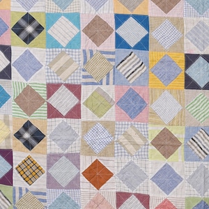 May include: A patchwork quilt constructed from various fabric squares featuring a repeating diamond pattern. The quilt displays a diverse array of colours including blue, yellow, brown, pink, green, and white, with assorted textures like plaid, stripes, and solid weaves.