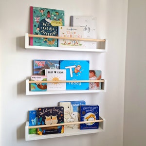 Floating white nursery bookshelf with natural oak accents, eco friendly storage for modern baby rooms