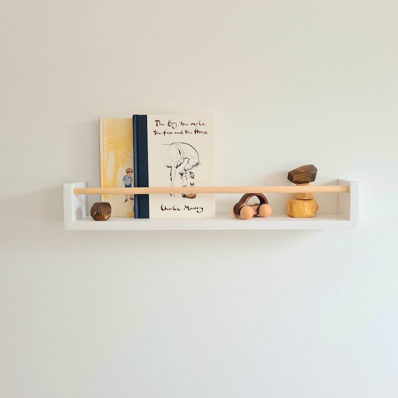 Scandi nursery wall shelf in white wood with oak rail, perfect for displaying baby shower gifts and décor