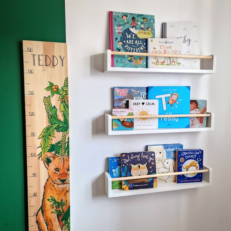 Handmade white nursery shelf with oak rail, floating bookshelf for children’s books and baby room essentials
