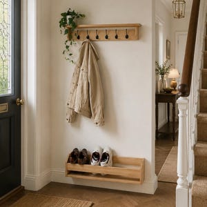 Contemporary oak shoe rack providing elegant shoe storage for hallways and entryways.