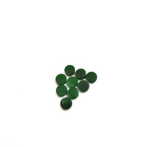 May include: A collection of ten round, flat, polished green stones arranged in a triangular shape against a white background. The stones have a smooth, reflective surface and vary slightly in shade.