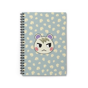 May include: A spiral bound notebook with a light blue background and a white pattern of leaves. The front cover features a cartoon image of a white and grey squirrel with a grumpy expression.