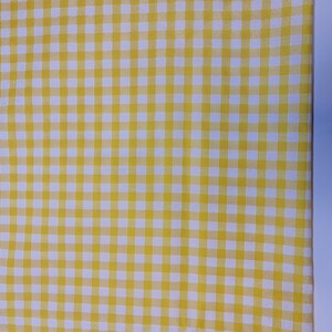 May include: Yellow and white checkered fabric with a fine weave. The fabric has a subtle sheen and is perfect for crafting projects.