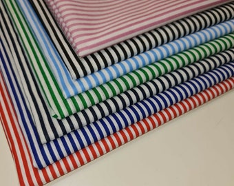 May include: A stack of striped fabric in various colors, including pink, black, blue, green, navy, and red.