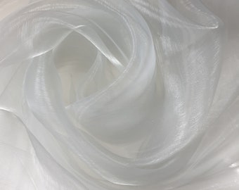 May include: White sheer fabric with a soft, flowing texture. The fabric is translucent and has a subtle shimmer.