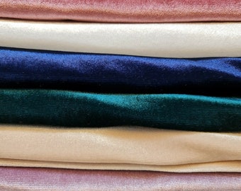 May include: Stack of six velvet fabric swatches in various colors, including pink, white, navy blue, green, beige, and mauve.