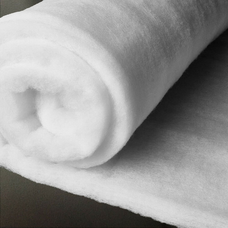 May include: A roll of white polyester fibrefill batting, a soft and fluffy material used for stuffing crafts, toys, and cushions.