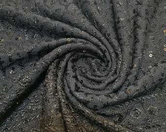 May include: Black fabric with a subtle floral pattern and small sequins throughout.