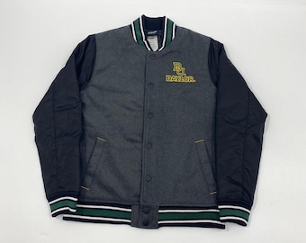 May include: A gray and black Baylor Bears varsity jacket. The jacket features a gray body with black sleeves, a button-up front, and the Baylor logo in gold. The collar and cuffs have green and white stripes.