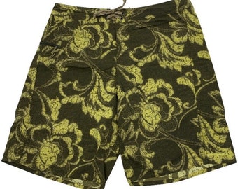 May include: Dark green board shorts featuring a yellow floral design. The shorts have a drawstring and a small side pocket. The Patagonia logo is visible on the bottom right.