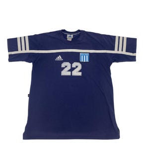 May include: Navy blue Adidas soccer jersey with white stripes on the sleeves and a white horizontal stripe across the chest. Features the number 22 in white, the Adidas logo, and a Racing Club patch.