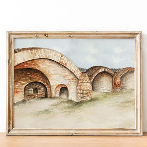 May include: Watercolor painting of a brick archway with a window in the left arch. The painting is framed in a light wood frame.