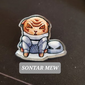 May include: A cartoon cat wearing a blue and white outfit with a silver helmet. The cat has orange fur and angry eyes. The cat is sitting on a silver and blue object. The text "SONTAR MEW" is below the cat.