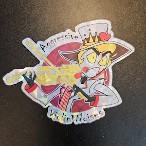 May include: A holographic sticker featuring a cartoon character with yellow hair, a red heart, and a crown. The character is playing a violin and the text "Aggressive Violin Noises" is written around the character.