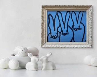"The Triumvirate" in a white frame