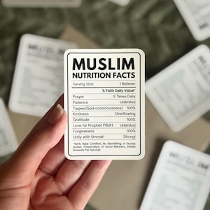 May include: A rectangular white sticker with black text titled Muslim Nutrition Facts. It lists spiritual values including Prayer 5 Times Daily, Patience Unlimited, Taqwa 100%, Kindness Overflowing, Gratitude 100%, Love for Prophet PBUH Unlimited, Forgiveness 100%, and Unity with Ummah Strong.