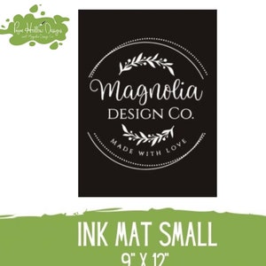 May include: A black rectangular ink mat featuring a white circular logo with the text Magnolia Design Co. and Made With Love, surrounded by leaf illustrations. The mat includes text indicating it is an Ink Mat Small measuring 9 inches by 12 inches.