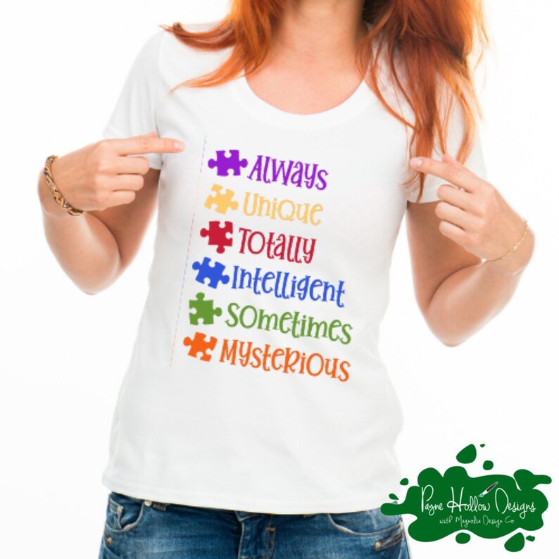 May include: A white short-sleeved t-shirt featuring a vertical list of six colorful puzzle pieces followed by the words Always, Unique, Totally, Intelligent, Sometimes, and Mysterious in matching purple, yellow, red, blue, green, and orange text.
