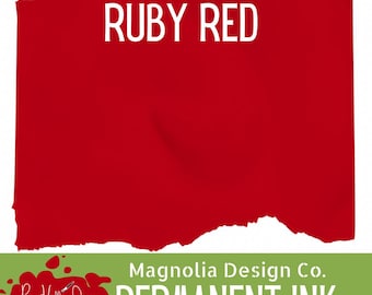May include: A rectangular swatch of ruby red ink with torn, uneven edges. Below the red area, a green banner displays the white text Magnolia Design Co. PERMANENT INK, alongside a red paint splatter logo with the text Payne Hollow Designs.