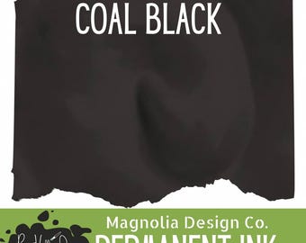 May include: A swatch of coal black permanent ink with a torn paper edge effect. The text COAL BLACK is printed in white at the top. A green banner at the bottom displays the text Magnolia Design Co. PERMANENT INK and a logo for Payne Hollow Designs.