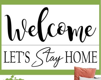 May include: A reusable silkscreen stencil featuring the black text Welcome and LET'S STAY HOME on a white background. The stencil is displayed with a coral pillow and a white pillow with the text LET'S STAY HOME printed on it.