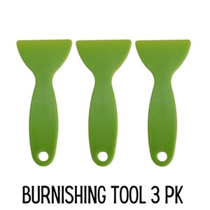 May include: A set of three lime green plastic burnishing tools, each featuring a wide, flat edge and a narrow handle with a circular hole at the base. The text BURNISHING TOOL 3 PK is printed in black capital letters below the three tools.