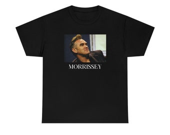 May include: Black t-shirt with a photo of Morrissey, a British singer, songwriter, and author. The text "MORRISSEY" is printed below the photo.