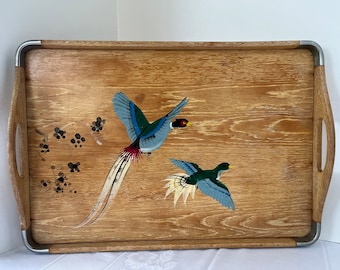 May include: A wooden serving tray with silver metal handles. The tray has a painted design of two birds, one blue and green and the other green and blue, with a white background.