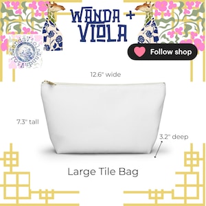 May include: A white Large Tile Bag with a gold zipper, measuring 12.6 inches wide, 7.3 inches tall, and 3.2 inches deep. The bag has the text "Large Tile Bag". The shop name "Wanda + Viola" is displayed above the bag.