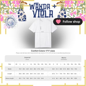 K&ouml;nnte beinhalten: Wei&szlig;es T-Shirt mit dem Text "WANDA + VIOLA" in Marineblau. Das Bild enth&auml;lt eine Gr&ouml;&szlig;entabelle mit Ma&szlig;en in Zentimetern. Der Shop-Name "Wanda + Viola" wird mit Giraffenillustrationen angezeigt.