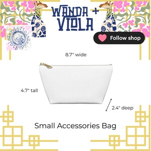 Puede incluir: Peque&ntilde;o neceser blanco con cremallera dorada, de 22 cm de ancho, 12 cm de alto y 6 cm de profundidad. La bolsa tiene el texto "Wanda + Viola" y "Small Accessories Bag".