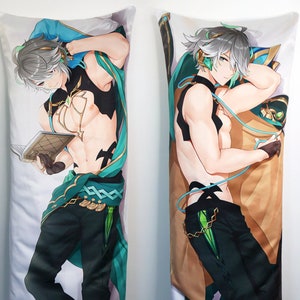 May include: A pair of body pillows featuring a character with silver hair, green eyes, and a green and gold outfit. The character is depicted in two different poses, one with a book and the other with headphones.