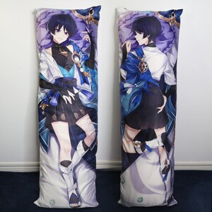 May include: A long body pillow featuring an anime character with blue hair, wearing a blue and white outfit with a black skirt. The character is standing with their arms raised, and the background is a purple and white pattern.