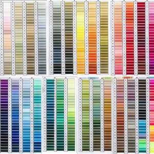 May include: A collection of color charts displaying a wide range of thread colors. The charts are arranged in rows and columns, showcasing various shades of beige, gray, yellow, orange, red, pink, purple, blue, green, and more. Each color is labeled with a number.