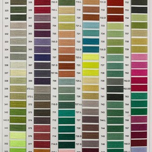 May include: A color chart of embroidery floss with numbered thread colors. The chart is organized by color families, with each color family represented by a vertical strip. The chart includes a variety of colors, including red, green, blue, yellow, and brown.