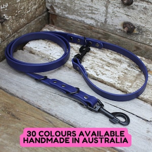 May include: A deep blue dog lead with black metal fixings, including a swivel clasp and rivets. The lead is made of a smooth, durable material. The image includes text that reads "30 COLOURS AVAILABLE HANDMADE IN AUSTRALIA".