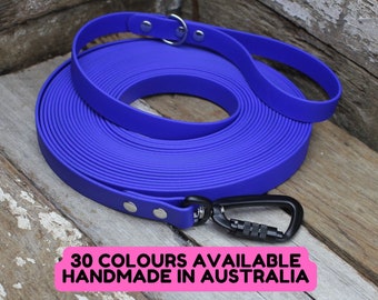 May include: A rolled-up, vibrant blue dog leash with a black carabiner clip and a handle. The leash is made of a flat, durable material. Text on the image reads "30 COLOURS AVAILABLE HANDMADE IN AUSTRALIA."