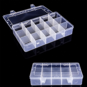 May include: A clear plastic storage organiser box featuring a hinged lid with two secure latches. The interior is divided into fifteen individual rectangular compartments by removable dividers, providing organised storage for small items.