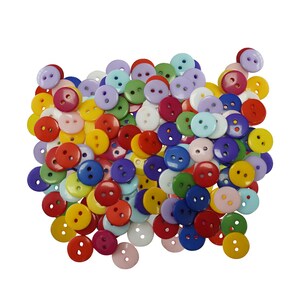 May include: A large collection of small, round, two-hole plastic buttons in a vibrant assortment of colours including red, blue, yellow, green, purple, pink, and white. These circular fasteners are scattered together in a dense, overlapping pile.