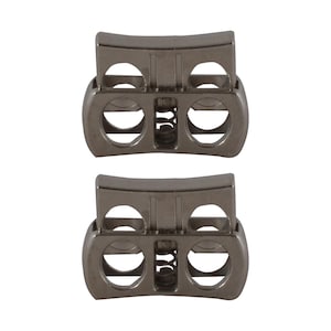 May include: Two silver-toned metal cord stoppers with a spring mechanism. Each stopper has two holes for cords to pass through.