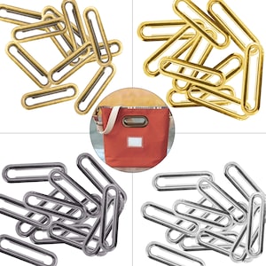 Könnte beinhalten: Ein Set mit 12 goldenen und 12 silbernen ovalen Metallringen. Die Ringe sind etwa 5 cm lang und 2,5 cm breit. Die Ringe werden zur Herstellung von Taschen und anderen Bastelarbeiten verwendet.